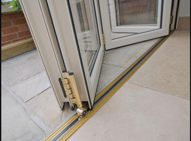 Close-up of a Liniar bi-fold door's hinges and low threshold track
