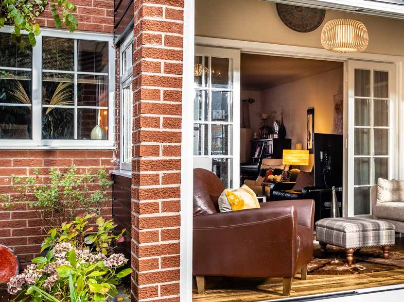 White PatioMaster UPVC sliding patio door with Georgian bar glazing on a brick home